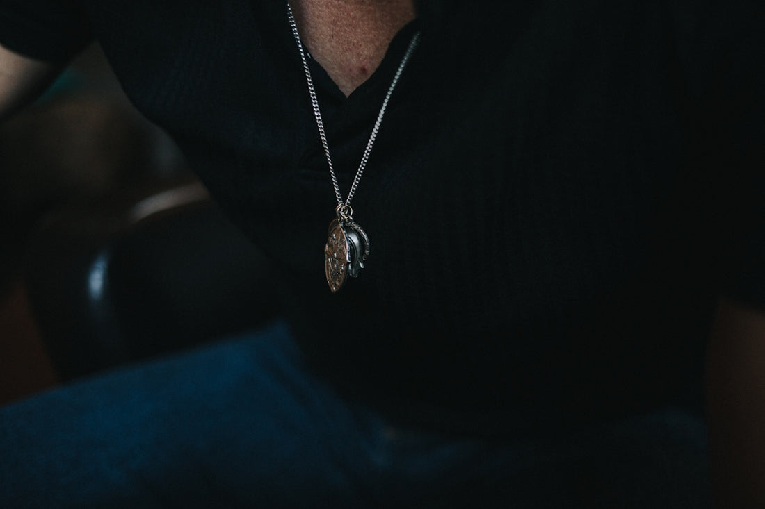 silver-colored pendant necklace