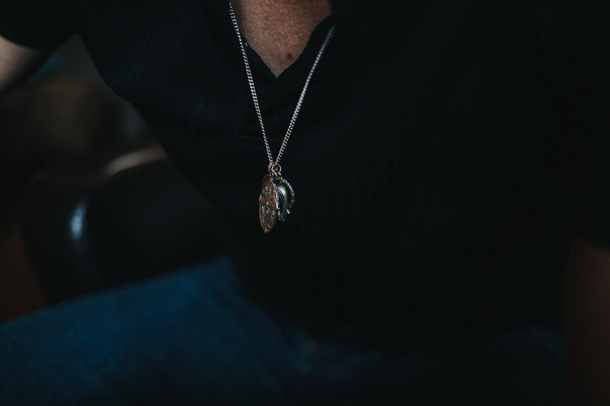 silver-colored pendant necklace