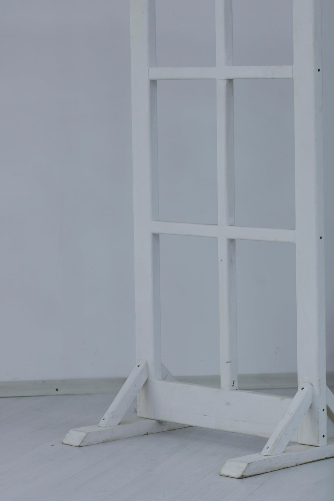 a white book shelf with three shelves on each side