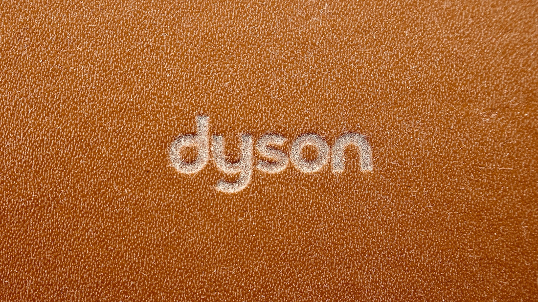 the word dyson written on a brown leather surface
