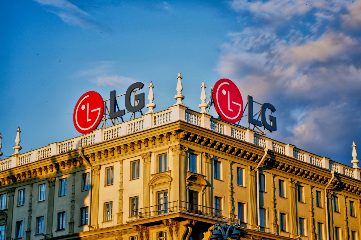 LG logos on a building roof under a blue sky